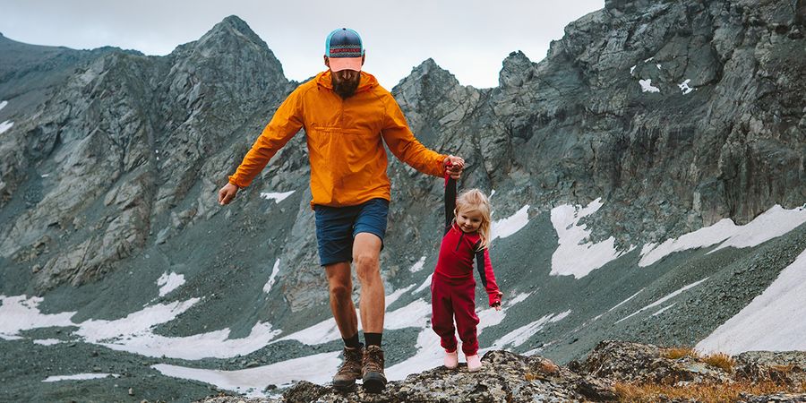 Un padre y su hija caminando en un paisaje de montaña, mostrando un plano general y los tipos de planos en fotografía con Hofmann.